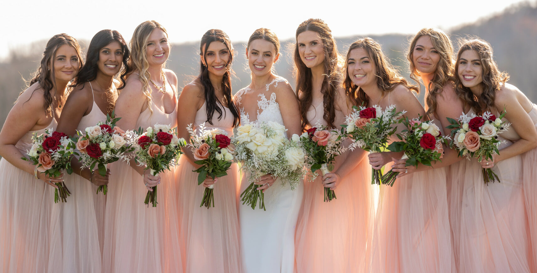 bridesmaids smiling with bouquet